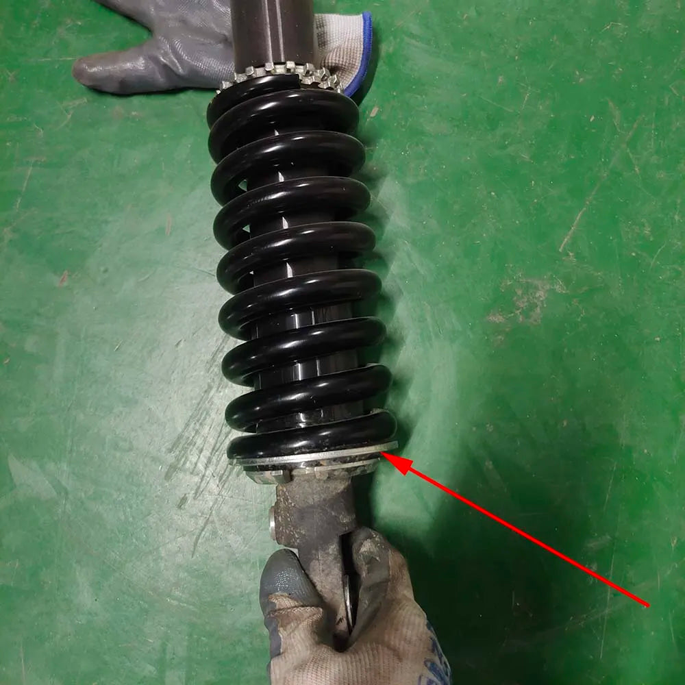 Lowering spacer position on rear shock spring