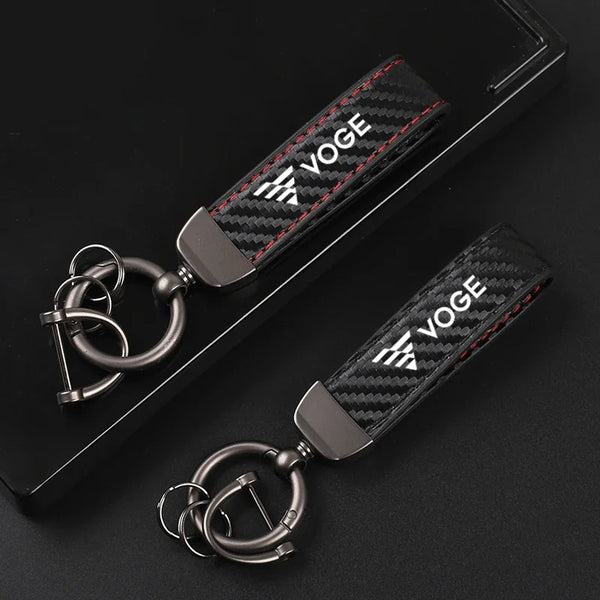 Two carbon fiber keychains with VOGE logo and metal key rings
