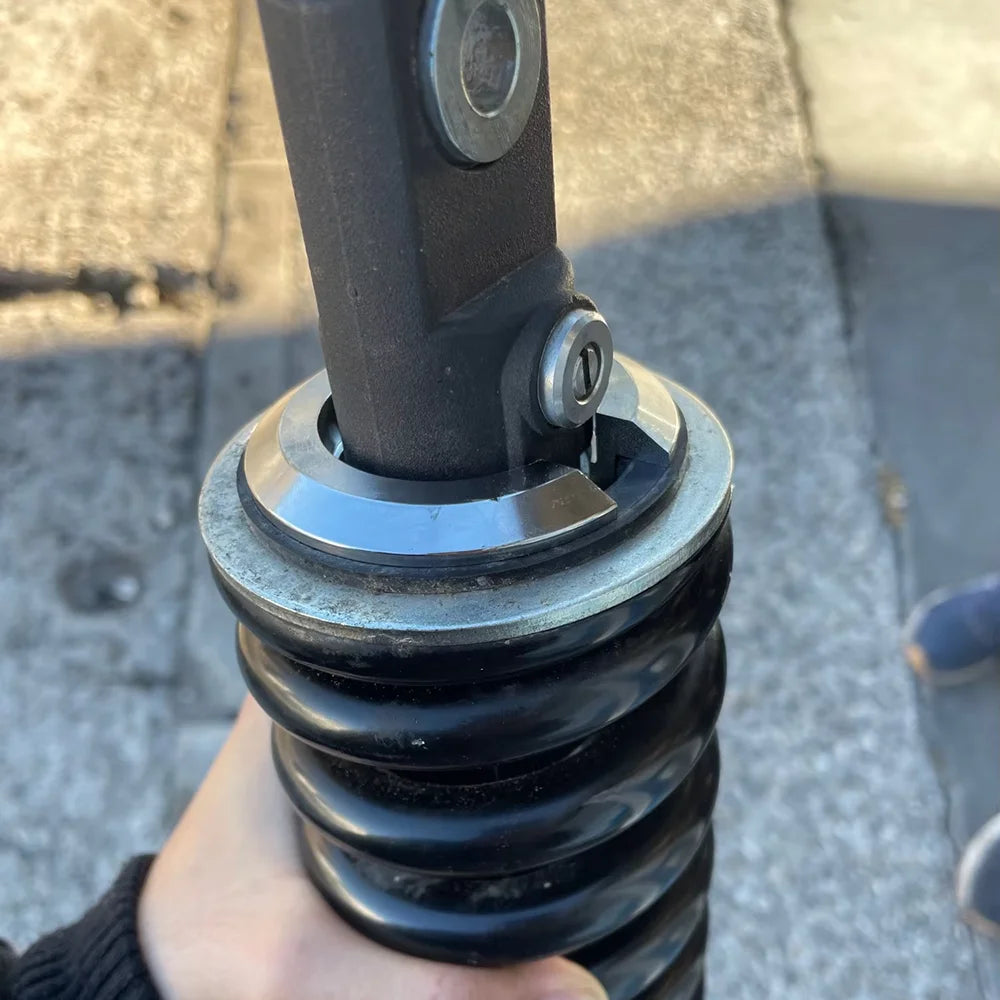 Lowering ring fitted under rear shock spring